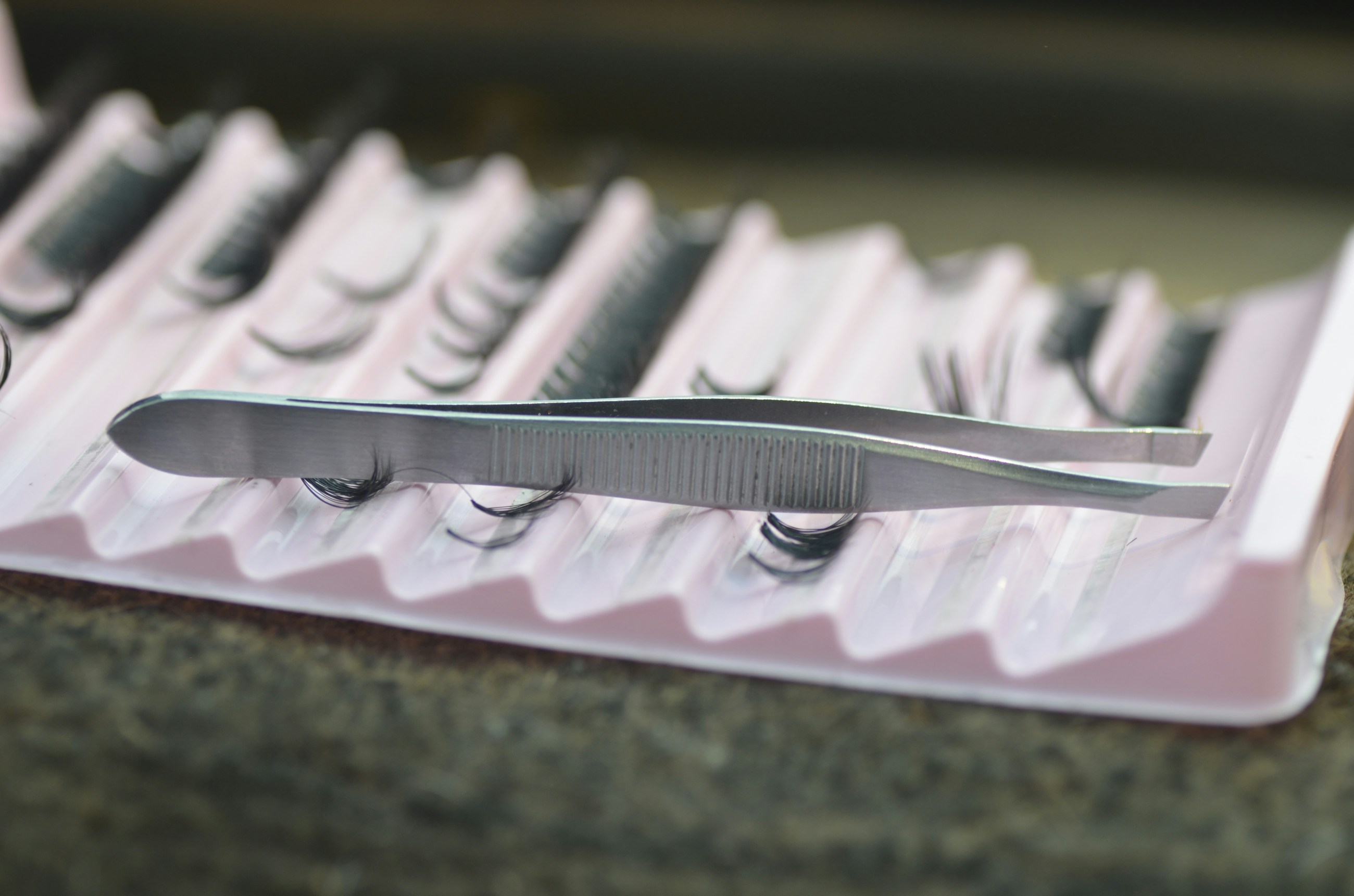 Hands-free placeholder of lash trays and tweezers for BeautifulClawz studio product education