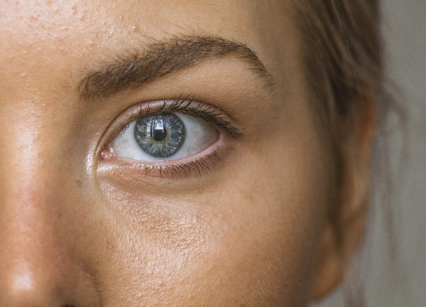 Close-up eye and brow detail placeholder for eyebrow waxing, tint, and beauty styling